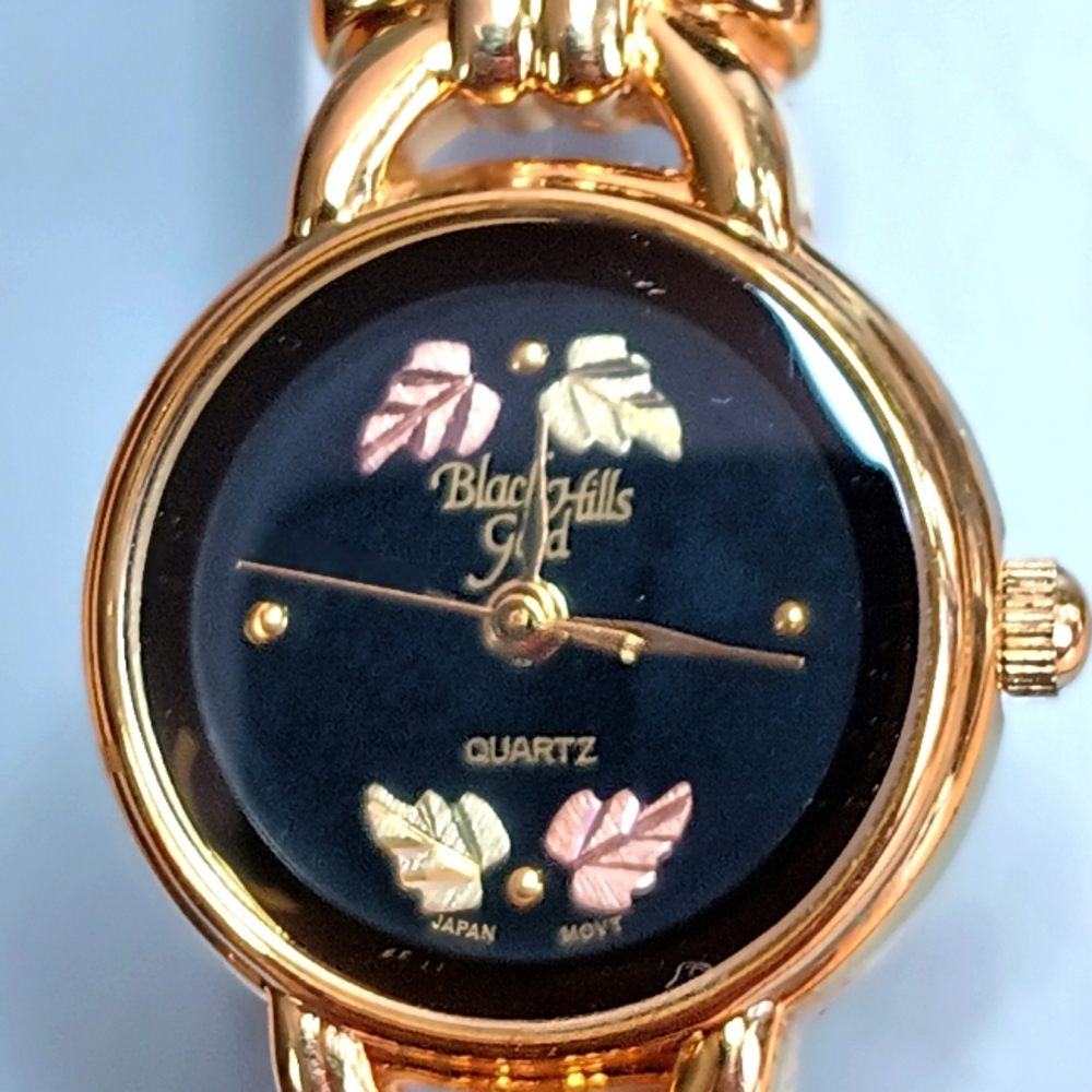 X Ladies Quartz Black Hills Gold watch. Gold tone case real gold leaves black
